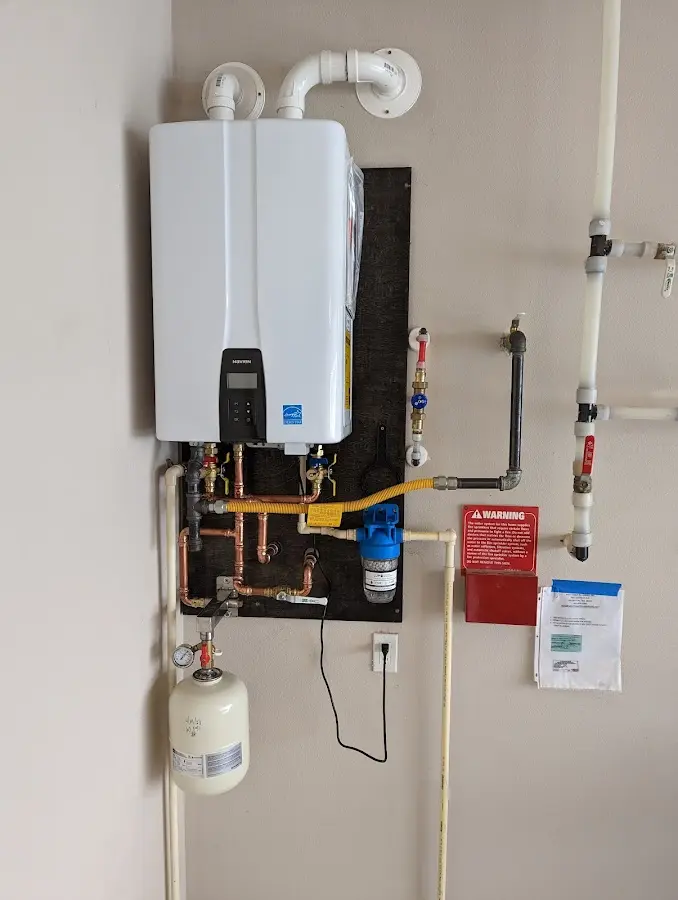 Professional plumber installing copper piping in a Billings home
